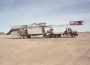 tridem-planetary-tractor-hauling-drilling-rig.jpg